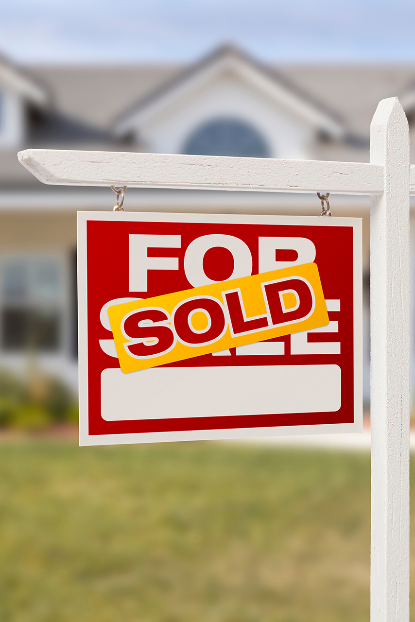 Red Sold For Sale Real Estate Sign in Front of House. Red Sold For Sale Real Estate Sign in Front of House.